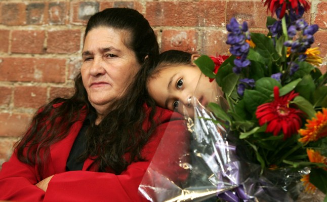 FILE - Maria Otone de Menezes, mother of Jean Charles de Menezes, left, is comforted by her granddaughter Giovana Oliver da Silva during a news conference in central London on Oct, 12, 2005. (AP Photo/Sergio Dionisio, File)