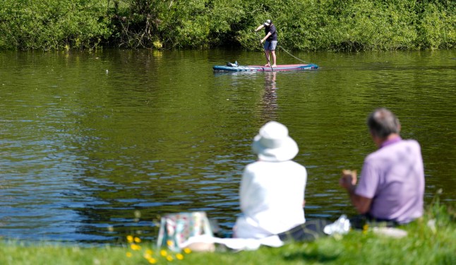 A person paddleboards on the River Thames in Runnymede, Surrey, as the warm weather continues across the country. Picture date: Wednesday April 30, 2025. PA Photo. See PA story WEATHER Warm. Photo credit should read: Andrew Matthews/PA Wire