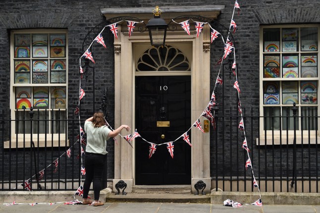 The Union flag bunting to commemorate the 75th anniversary of VE Day (Victory in Europe Day), the end of the Second World War in Europe is taken down from the exterior of 10 downing Street, on May 10, 2020. - Prime Minister will on Sunday unveil a new alert system to monitor the coronavirus outbreak but maintain a nationwide lockdown as Britain's death toll, the highest in Europe, continues to mount. (Photo by Glyn KIRK / AFP) (Photo by GLYN KIRK/AFP via Getty Images)