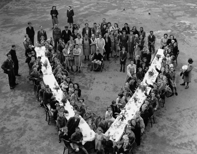(Original Caption) Victory Party For Children In South London. Children sat down to a Victory Party given by flat residents at Kentwell Close, Brockley in South London. May 1945. (Photo by ?? Hulton-Deutsch Collection/CORBIS/Corbis via Getty Images)