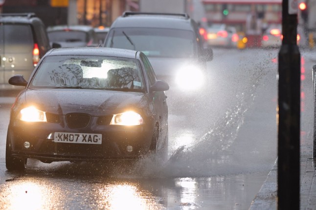 ??George Cracknell Wright 15/04/2025 London, United Kingdom London Wet Weather Vehicles make a splash as they are driven through a large puddle during heavy rain in Greenwich, South East London. Yellow weather warnings for rain are in place in parts of the United Kingdom . Photo Credit: George Cracknell Wright