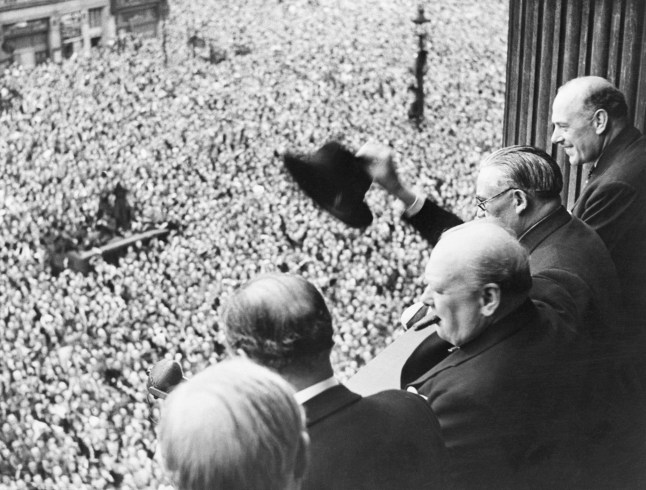 From a balcony in the Ministry of Health Building in Whitehall, Mr. Churchill addresses a huge crowd, 8th May 1945. Members of the cabinet were with him on the balcony. Photo shows the Prime Minister and a section of the huge crowd.
