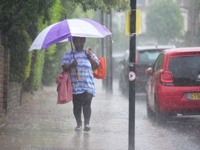 A person walks through the rain in Kentish Town.