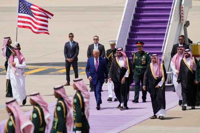 President Donald Trump walks with Saudi Crown Prince Mohammed bin Salman during an arrival ceremony at the Royal Terminal of King Khalid International Airport in Riyadh, Saudi Arabia, Tuesday, May 13, 2025