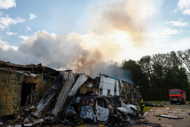 Firefighters work at the site of a private enterprise hit by a Russian drone strike, amid Russia's attack on Ukraine, outside of Kyiv, Ukraine May 18, 2025. REUTERS/Valentyn Ogirenko