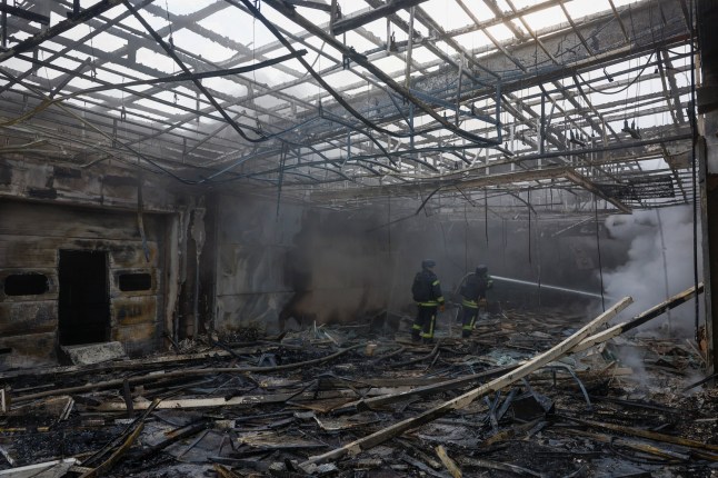 Firefighters work at the site of a private enterprise hit by a Russian drone strike, amid Russia's attack on Ukraine, outside of Kyiv, Ukraine May 18, 2025. REUTERS/Valentyn Ogirenko