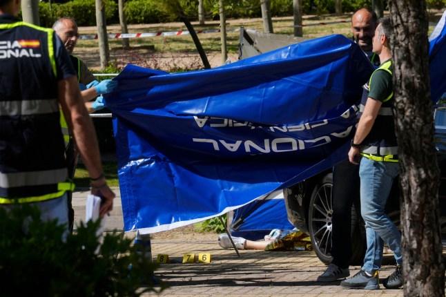 epa12121805 Police officers work at the scene outside the American School of Madrid in Pozuelo de Alarcon, Madrid, Spain, 21 May 2025, after a Ukrainian man, 52, was shot dead after dropping off his children at the school. EPA/BORJA SANCHEZ-TRILLO -- ATTENTION EDITORS: IMAGE PIXELATED AT SOURCE
