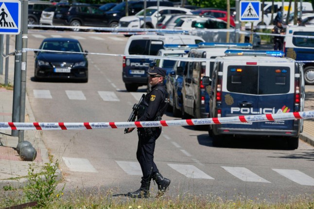 Police officers cordon off the area after an adviser to former Ukrainian president Viktor Yanukovych was shot, outside a school in Madrid, Spain, Wednesday, May 21, 2025. (AP Photo/Paul White)