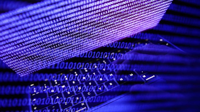 Binary code displayed on a laptop screen and binary code displayed on a screen are seen in this multiple exposure illustration photo taken in Krakow, Poland on September 27, 2022. (Photo by Jakub Porzycki/NurPhoto via Getty Images)